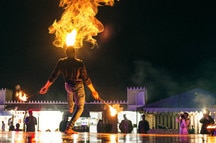 A fire blowing performance in desert safari camp in Dubai, UAE A fire blowing performance in desert safari camp in Dubai, UAE